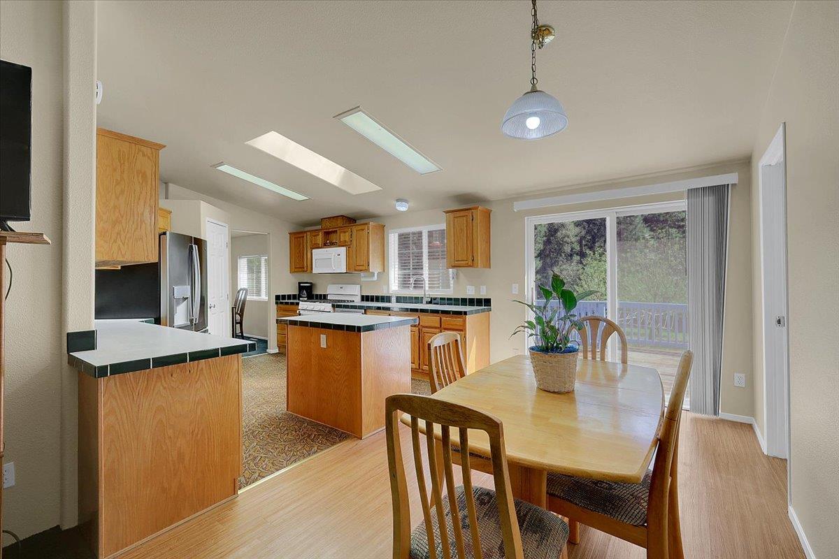 138 Big Fir Road Forbestown, CA 95941 - Photo 20 of 56 a dining room with stainless steel appliances granite countertop a stove a sink a refrigerator dining table and chairs