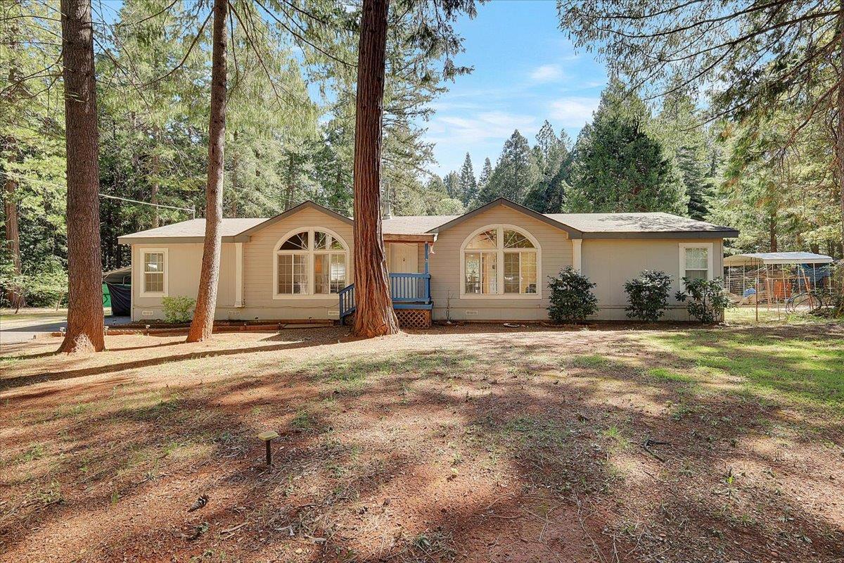 138 Big Fir Road Forbestown, CA 95941 - Photo 2 of 56 a front view of a house with a garden and pathway