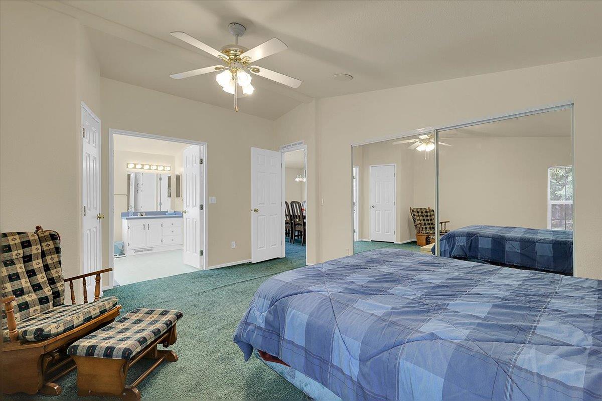 138 Big Fir Road Forbestown, CA 95941 - Photo 30 of 56 a spacious bedroom with a bed and a chandelier