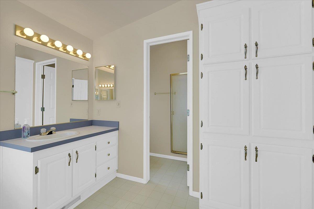 138 Big Fir Road Forbestown, CA 95941 - Photo 32 of 56 a bathroom with a granite countertop sink a mirror and a shower