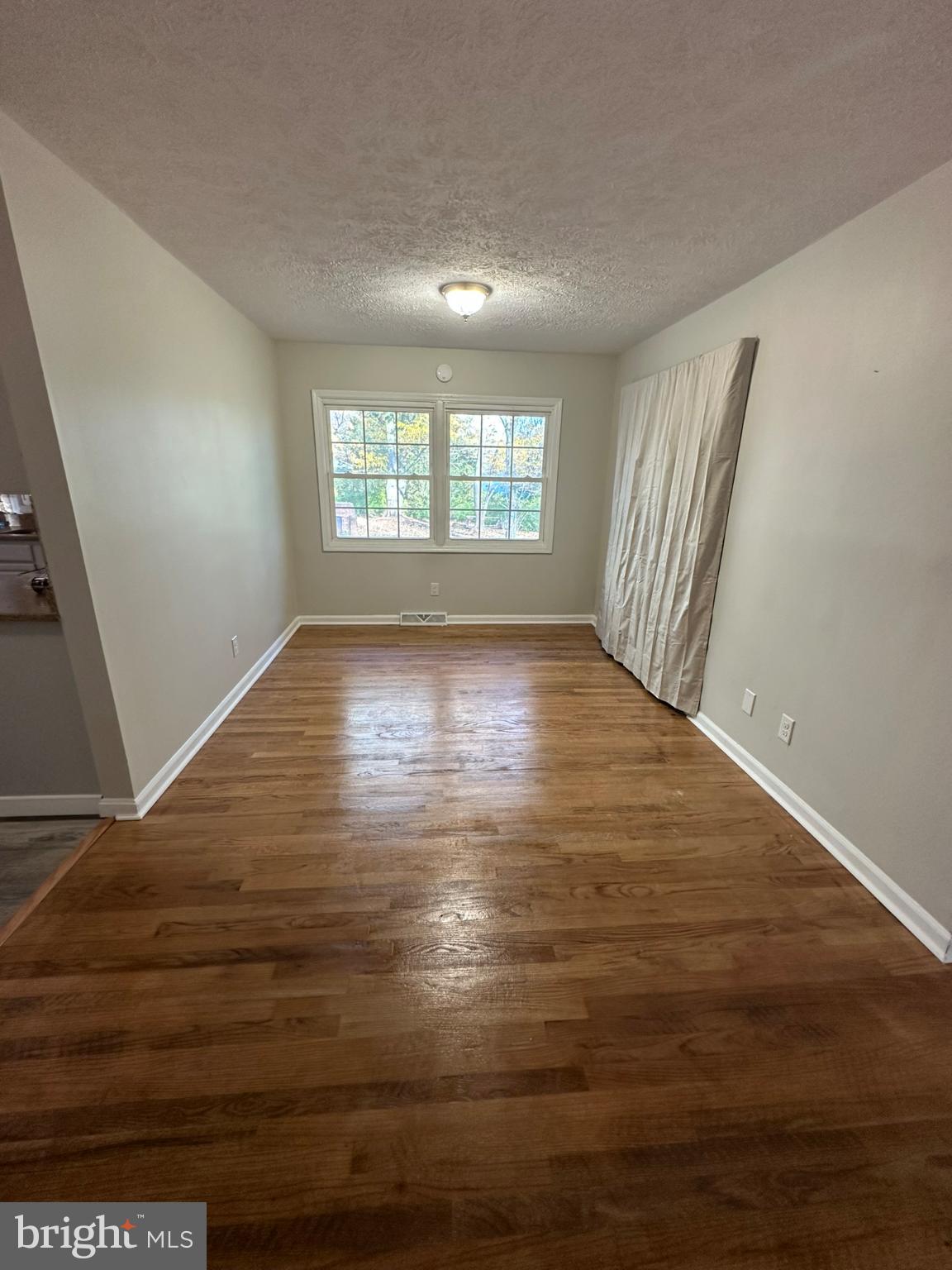 44075 Louisdale Road California, MD 20619 - Photo 13 of 26 an empty room with wooden floor and windows