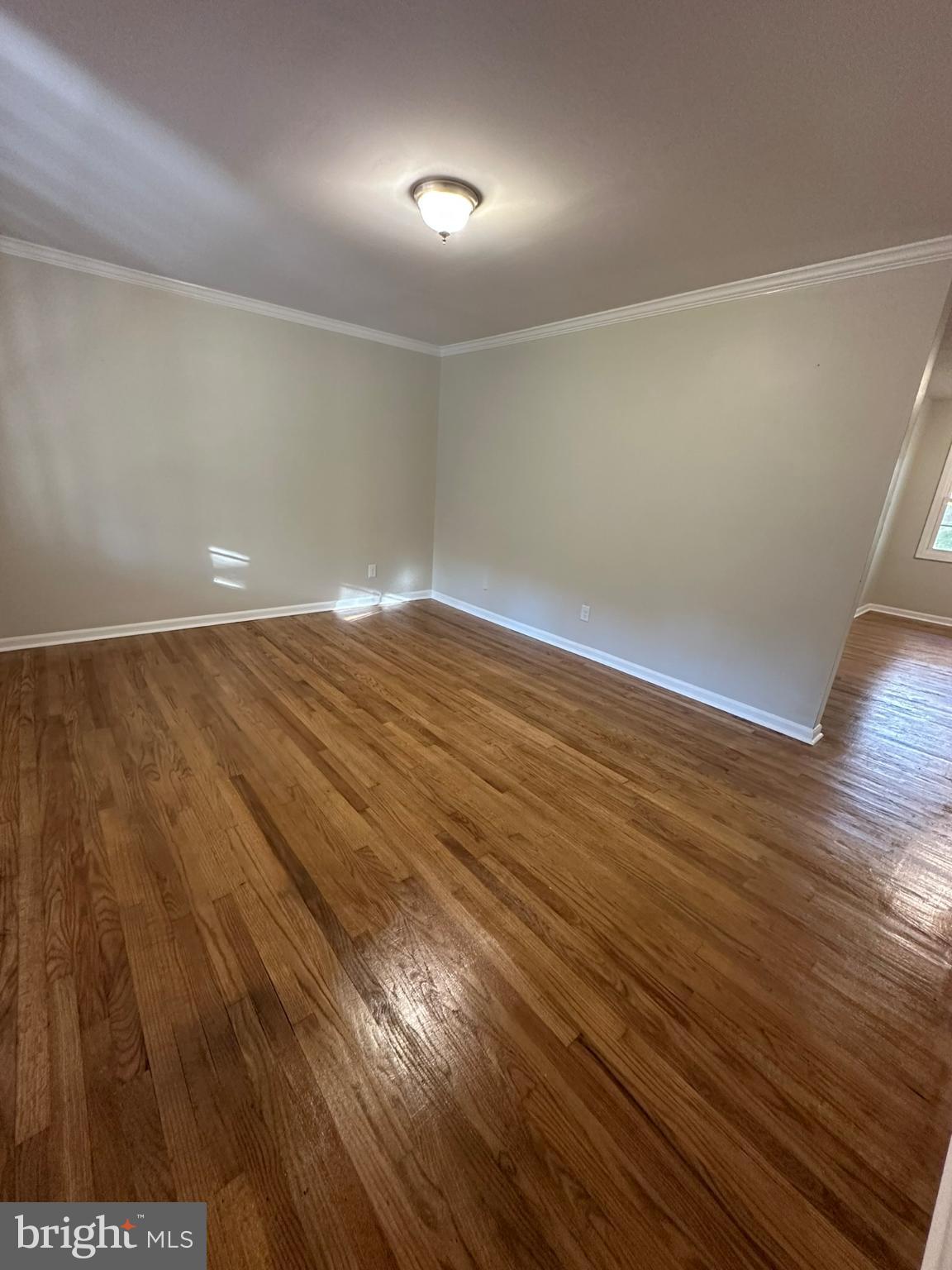 44075 Louisdale Road California, MD 20619 - Photo 14 of 26 an empty room with wooden floor and windows