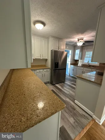 a kitchen with kitchen island sink refrigerator and stove
