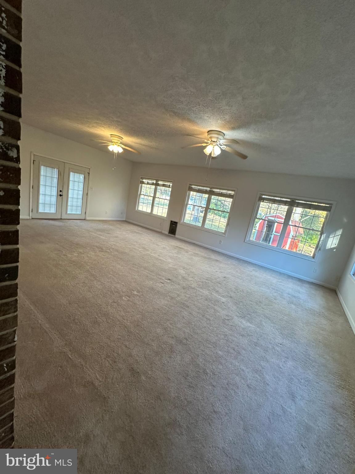 44075 Louisdale Road California, MD 20619 - Photo 19 of 26 a view of an empty room with windows and fireplace