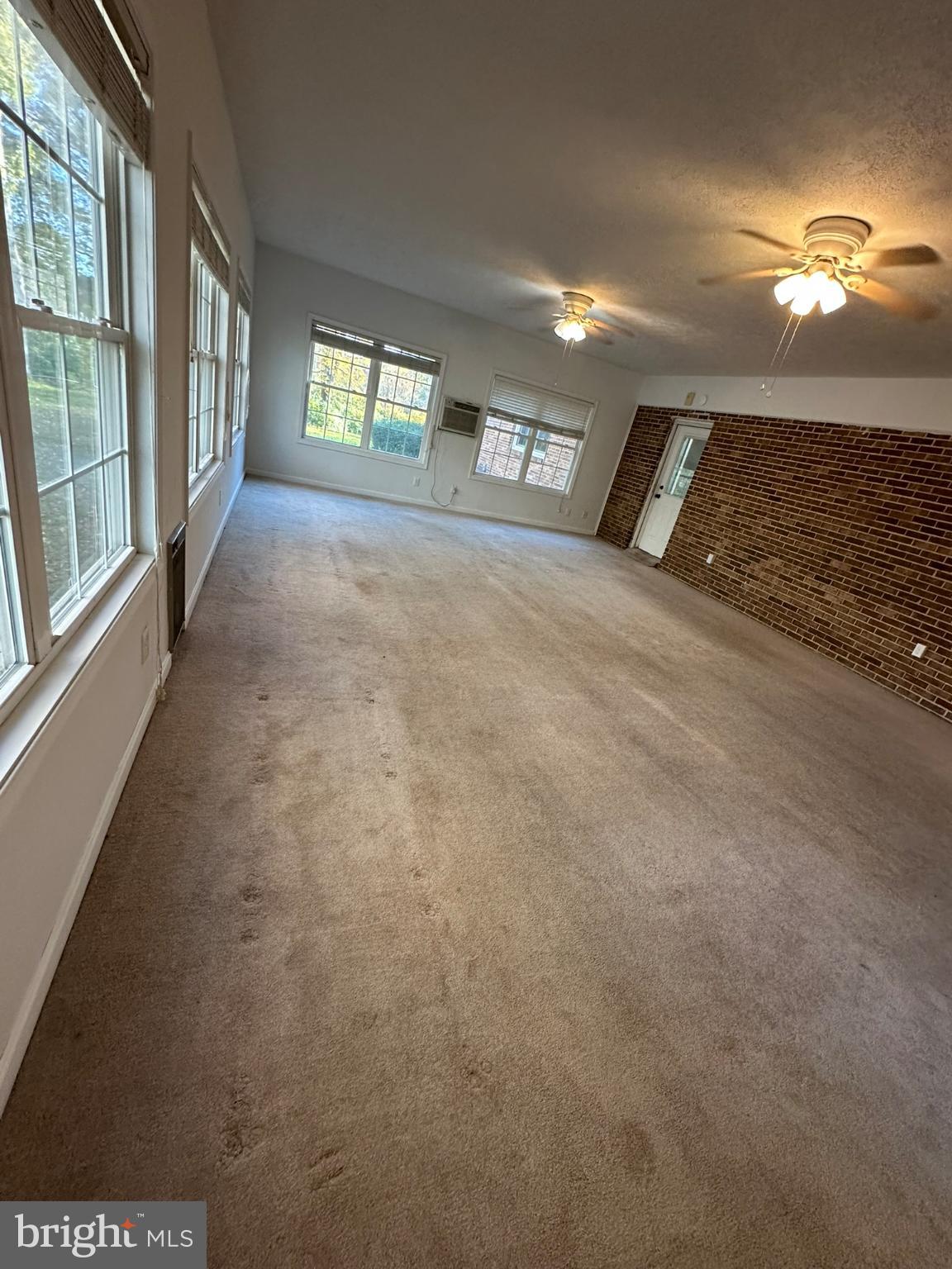 44075 Louisdale Road California, MD 20619 - Photo 20 of 26 a view of a livingroom with a ceiling fan and window