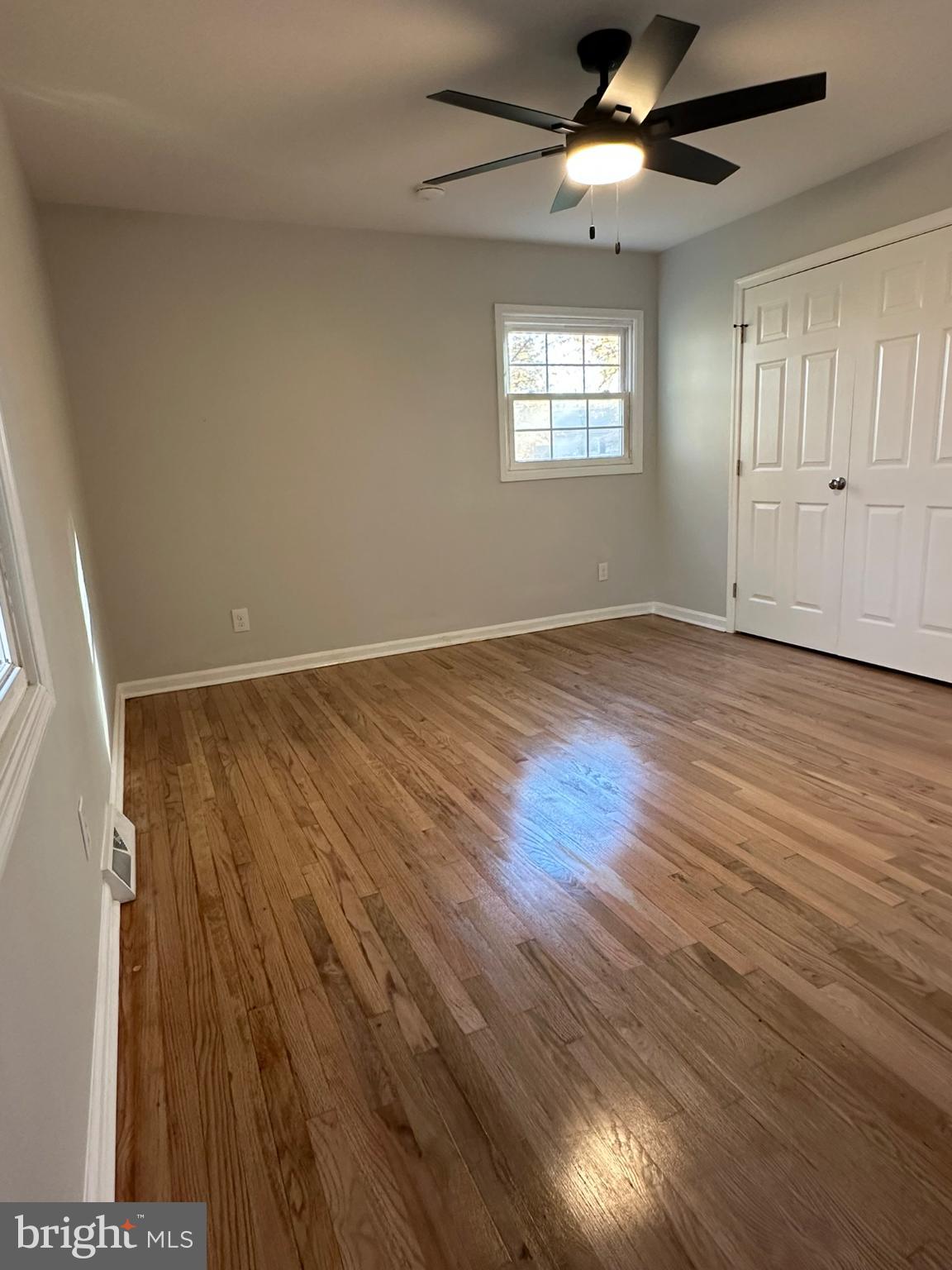 44075 Louisdale Road California, MD 20619 - Photo 3 of 26 an empty room with wooden floor fan and windows