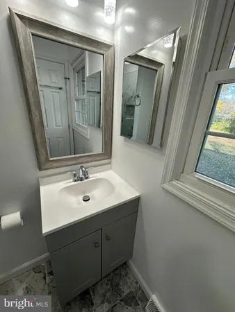 a bathroom with a sink a mirror and shower