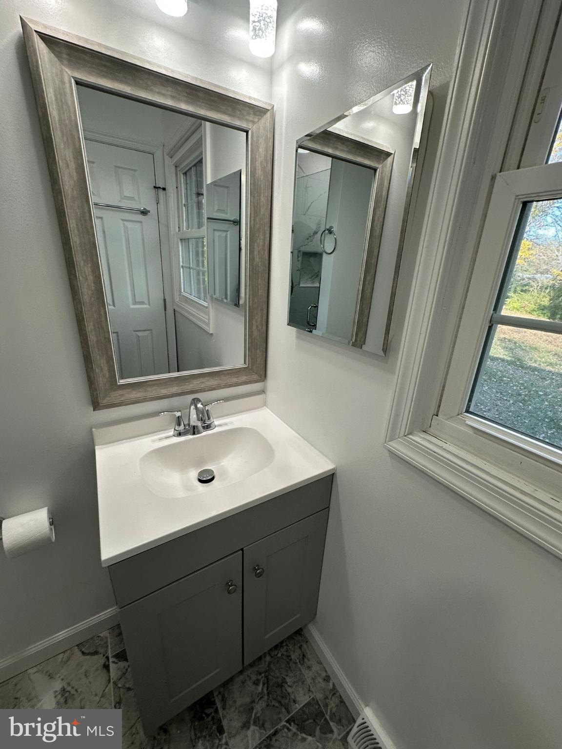44075 Louisdale Road California, MD 20619 - Photo 5 of 26 a bathroom with a sink a mirror and shower
