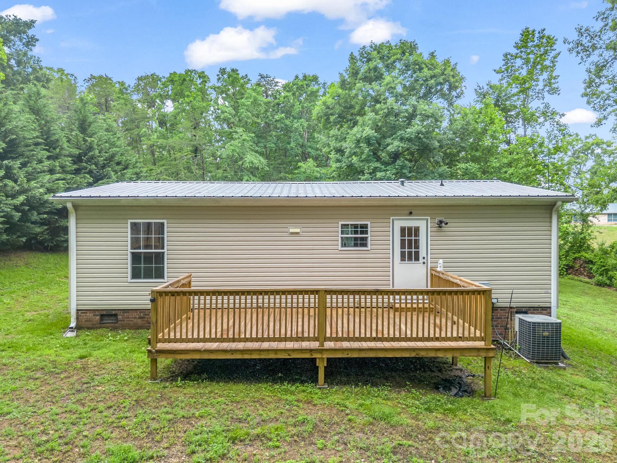 1449 Toney Road Bostic, NC 28018 - Photo 10 of 43 a view of a house with a yard and deck