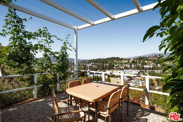 a view of a balcony dining table and chairs