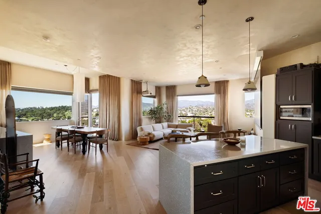 a kitchen with stainless steel appliances granite countertop a sink a stove and a wooden floors