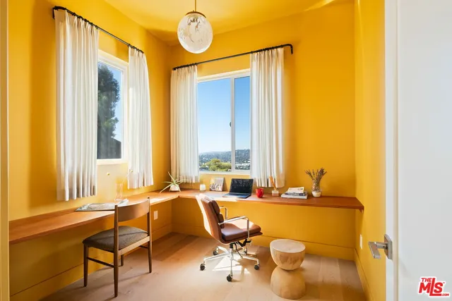 a living room with a table and chairs