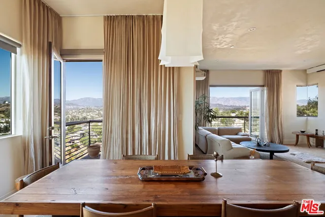 a view of a living room hardwood floor and a large window