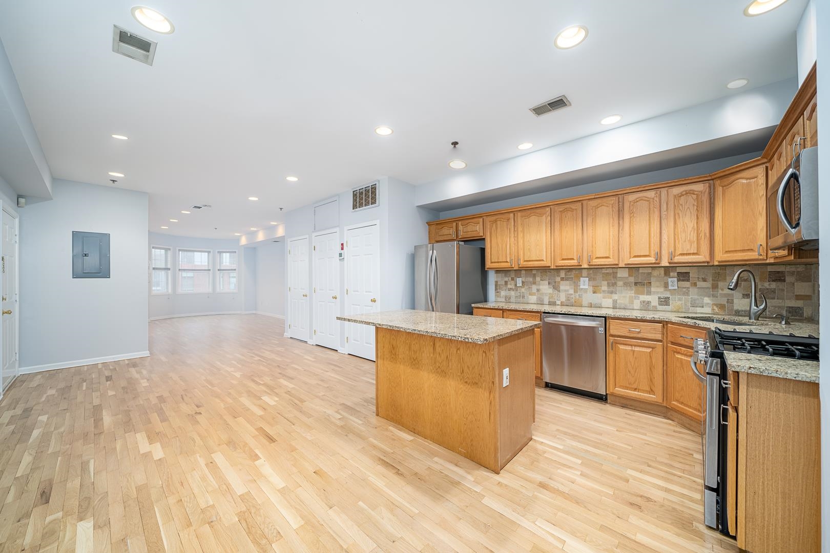 122 Monroe Street, Unit 3 Hoboken, NJ 07030 - Photo 1 of 24 a large kitchen with stainless steel appliances granite countertop a large counter top a stove a sink and a refrigerator