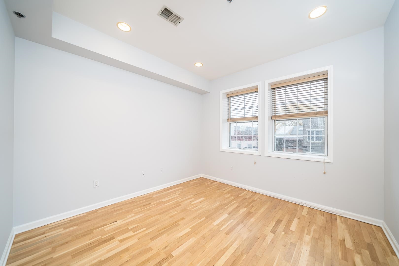 122 Monroe Street, Unit 3 Hoboken, NJ 07030 - Photo 11 of 24 a view of empty room with wooden floor and fan