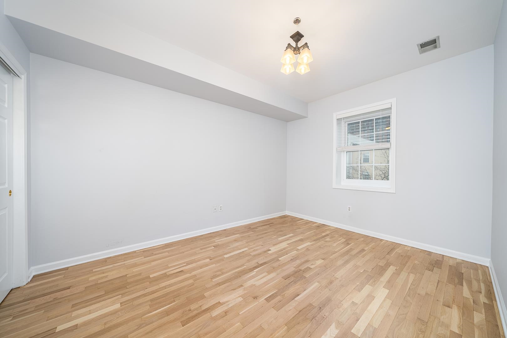 122 Monroe Street, Unit 3 Hoboken, NJ 07030 - Photo 15 of 24 a view of an empty room with a window