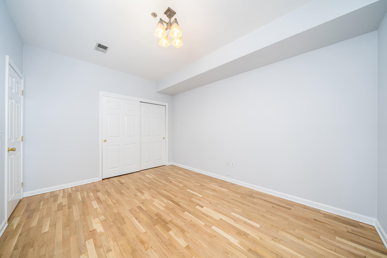 122 Monroe Street, Unit 3 Hoboken, NJ 07030 - Photo 17 of 24 a view of empty room with wooden floor