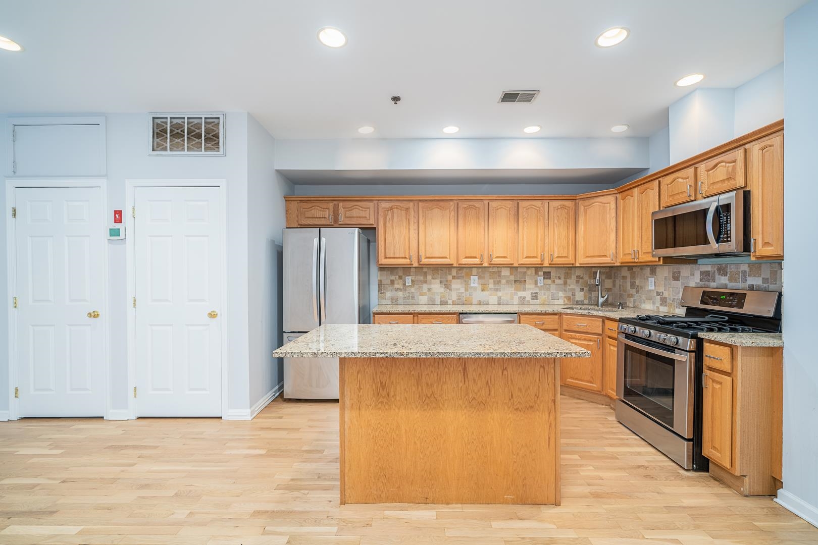122 Monroe Street, Unit 3 Hoboken, NJ 07030 - Photo 2 of 24 a large kitchen with stainless steel appliances granite countertop a stove and a refrigerator