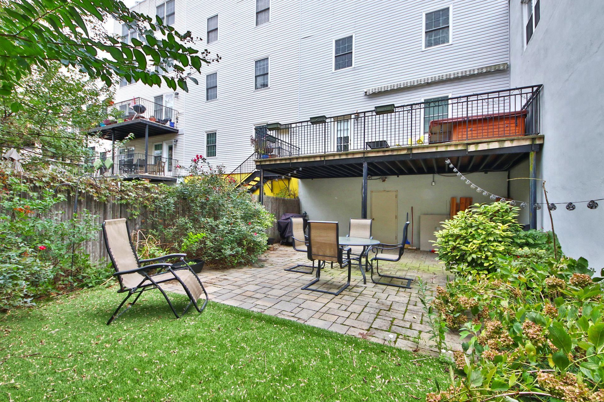 122 Monroe Street, Unit 3 Hoboken, NJ 07030 - Photo 23 of 24 a view of a patio with table and chairs and potted plants