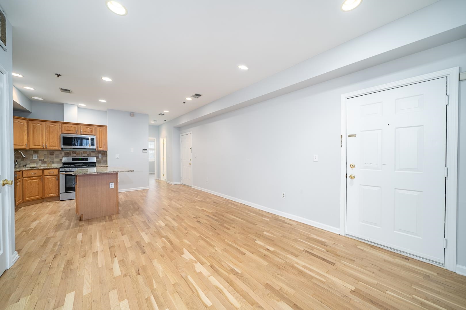 122 Monroe Street, Unit 3 Hoboken, NJ 07030 - Photo 5 of 24 a kitchen with stainless steel appliances a refrigerator and a stove top oven