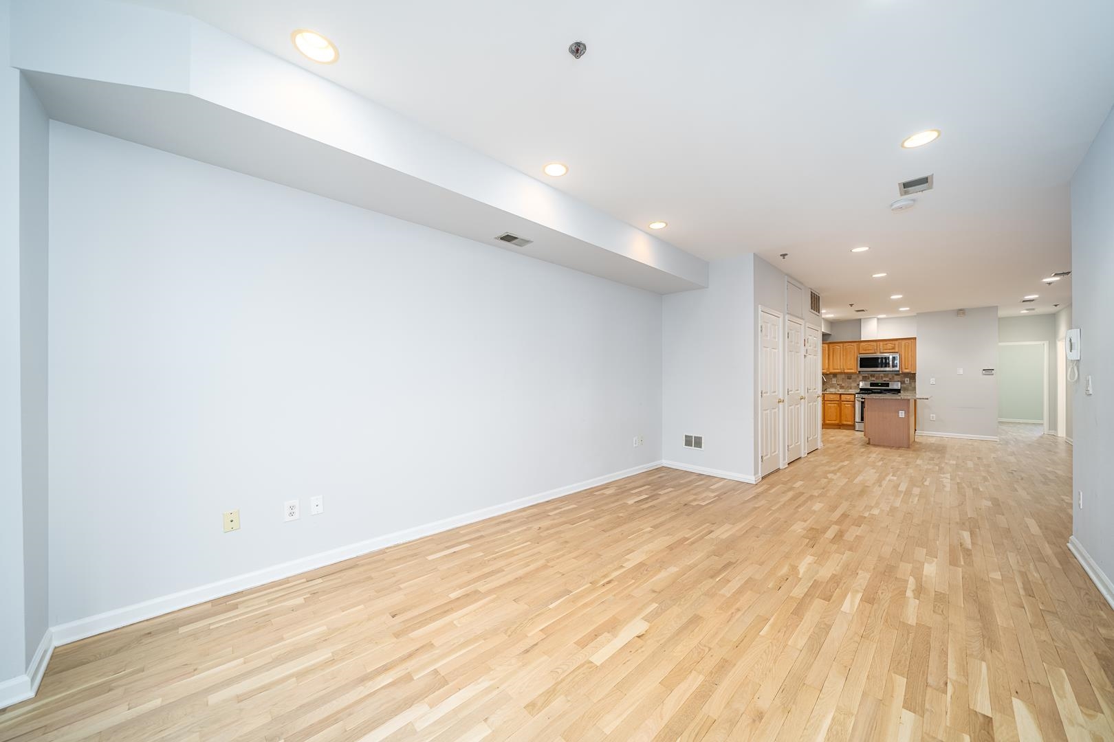 122 Monroe Street, Unit 3 Hoboken, NJ 07030 - Photo 7 of 24 a view of empty room with wooden floor