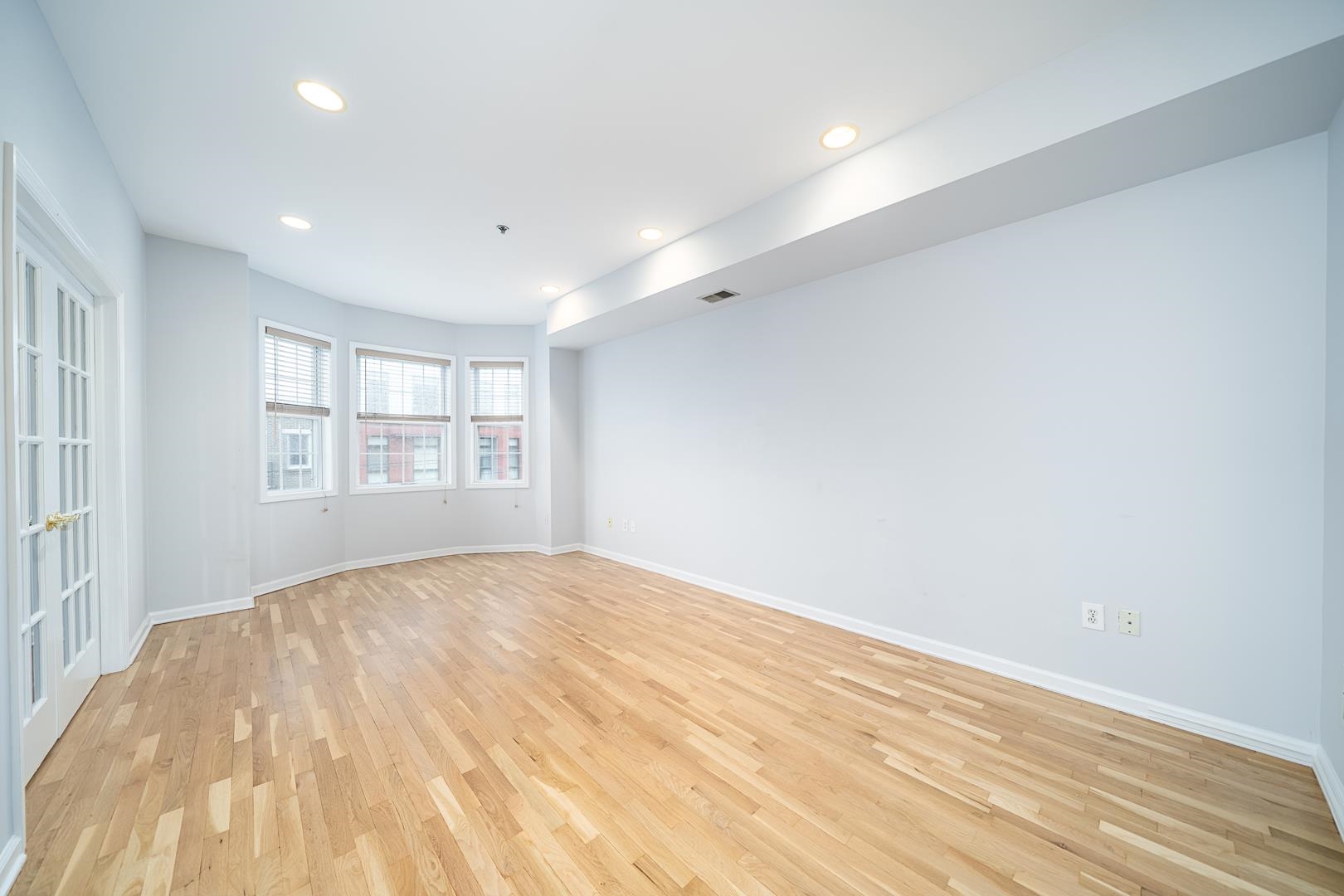 122 Monroe Street, Unit 3 Hoboken, NJ 07030 - Photo 8 of 24 a view of empty room with wooden floor and fan