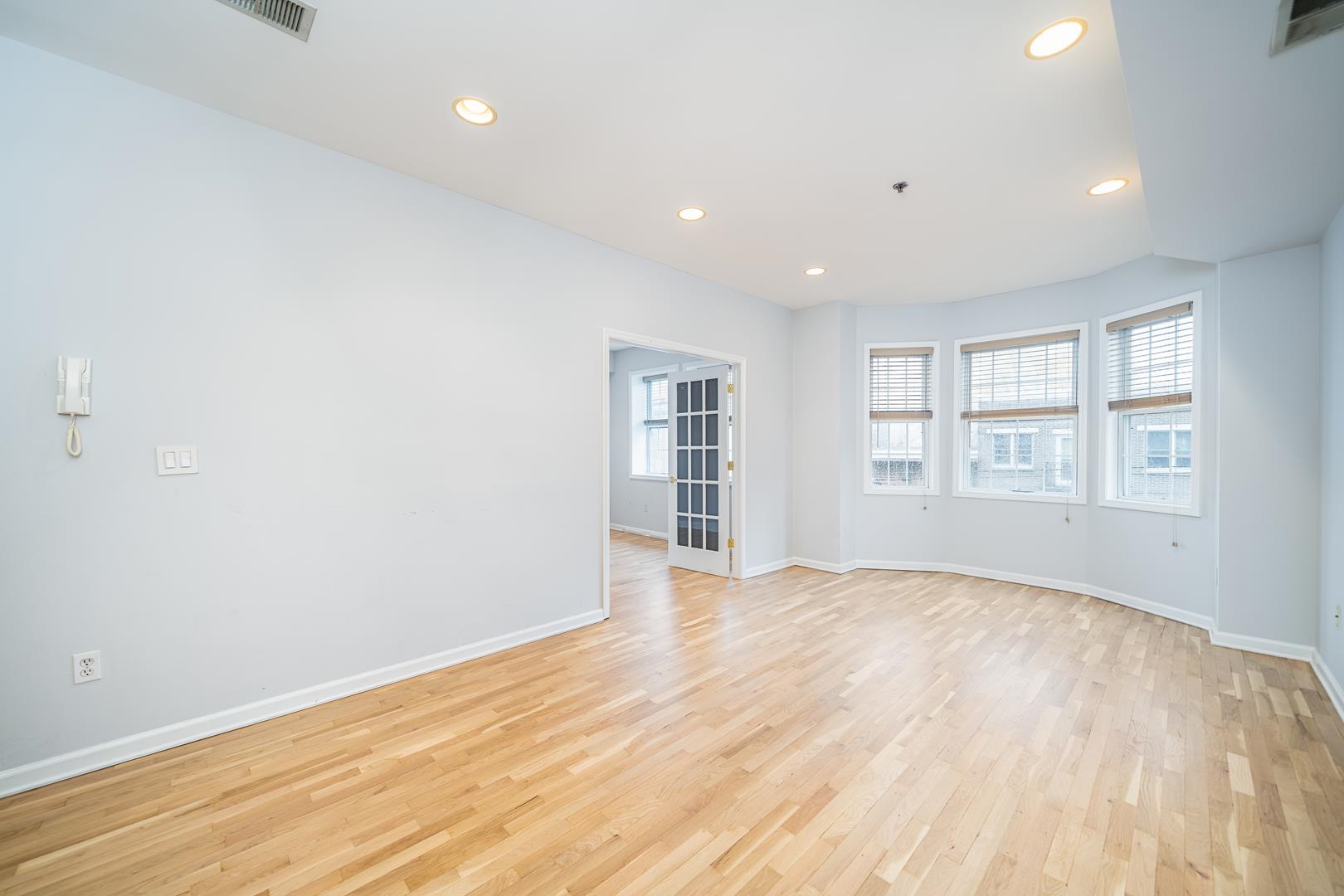 122 Monroe Street, Unit 3 Hoboken, NJ 07030 - Photo 10 of 24 a view of an empty room with a window and wooden floor