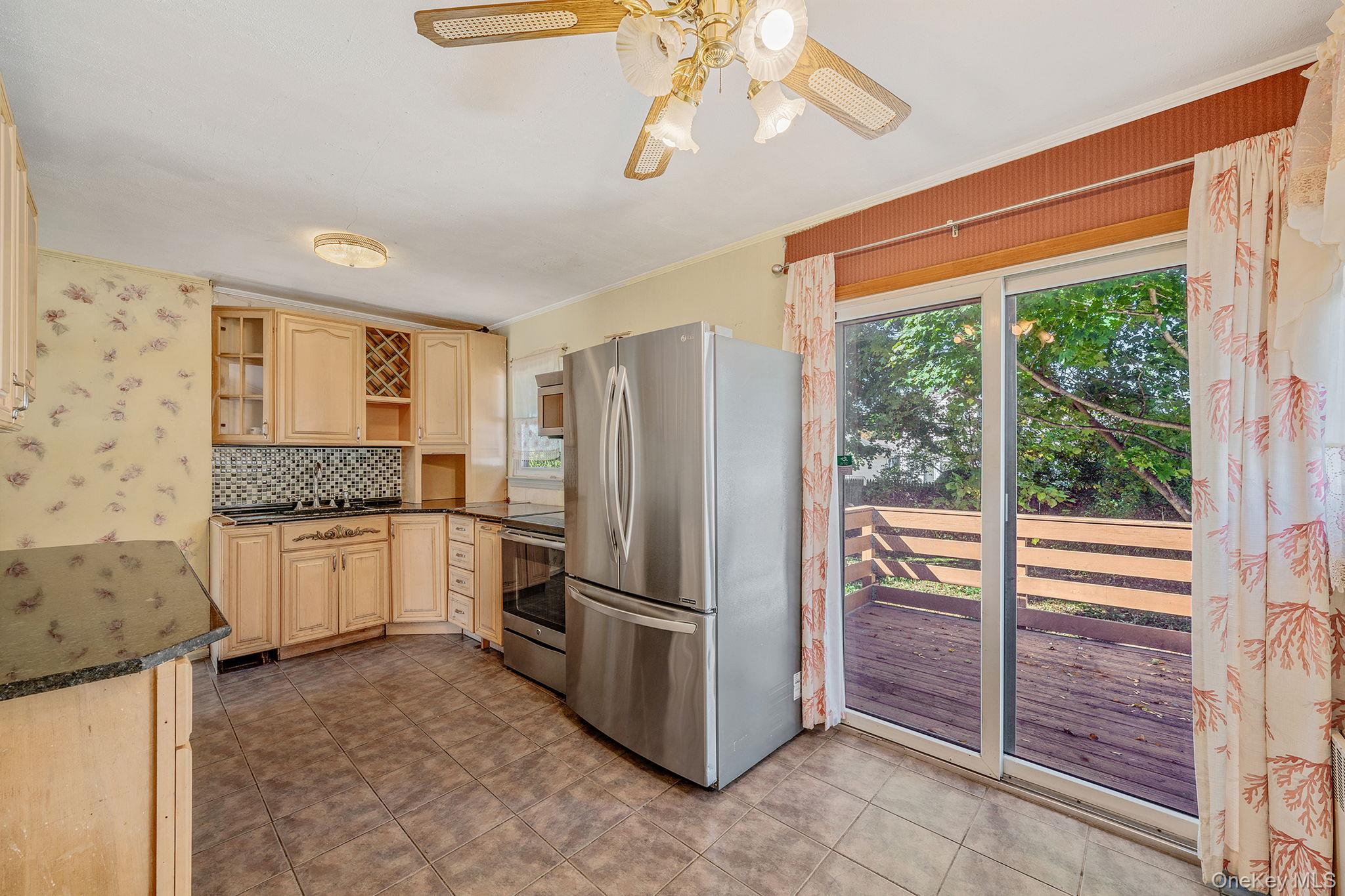 2001 North Jerusalem Road East Meadow, NY 11554 - Photo 13 of 31 a kitchen with stainless steel appliances granite countertop a refrigerator and microwave