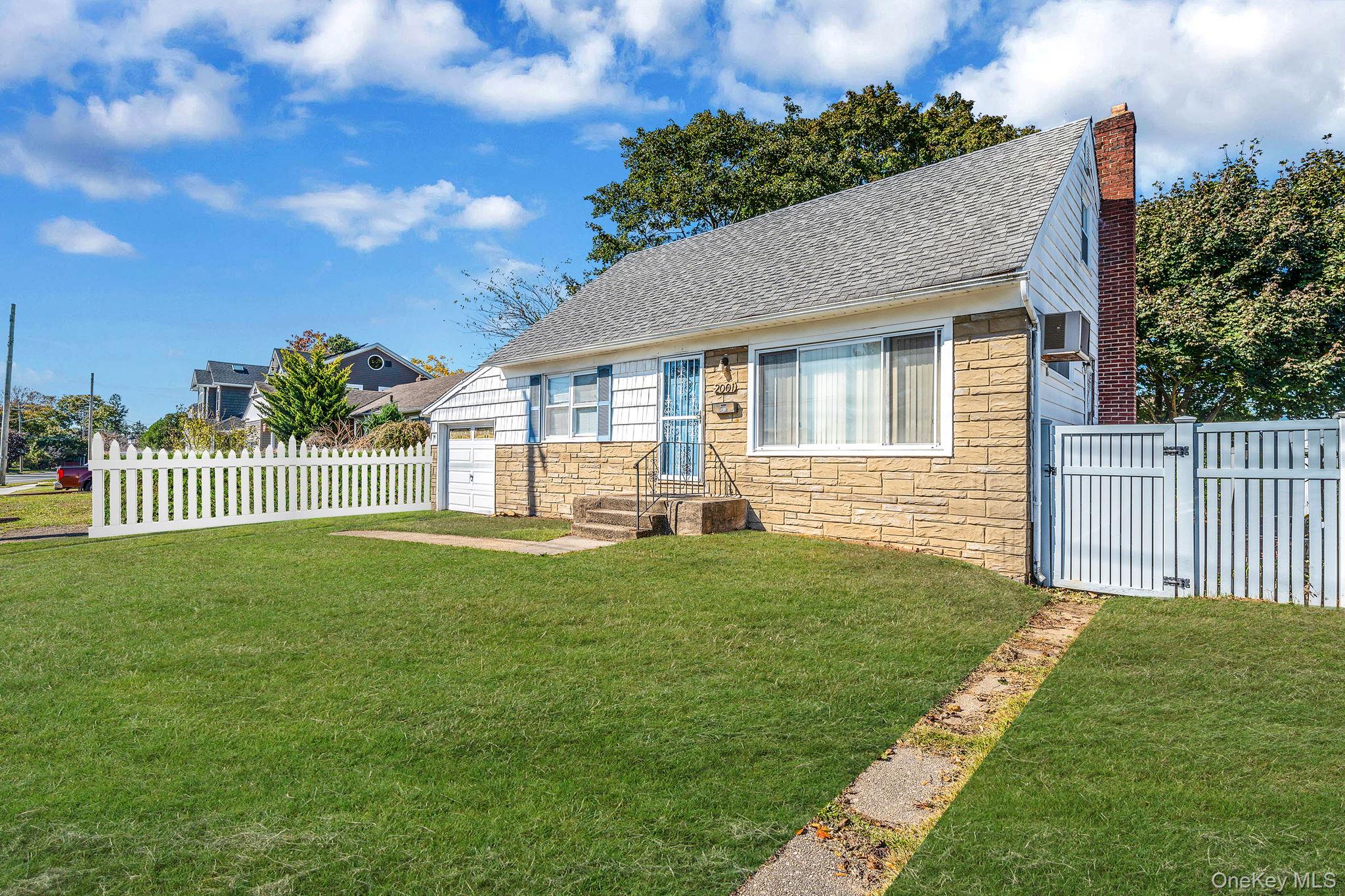 2001 North Jerusalem Road East Meadow, NY 11554 - Photo 2 of 31 a front view of a house with a garden