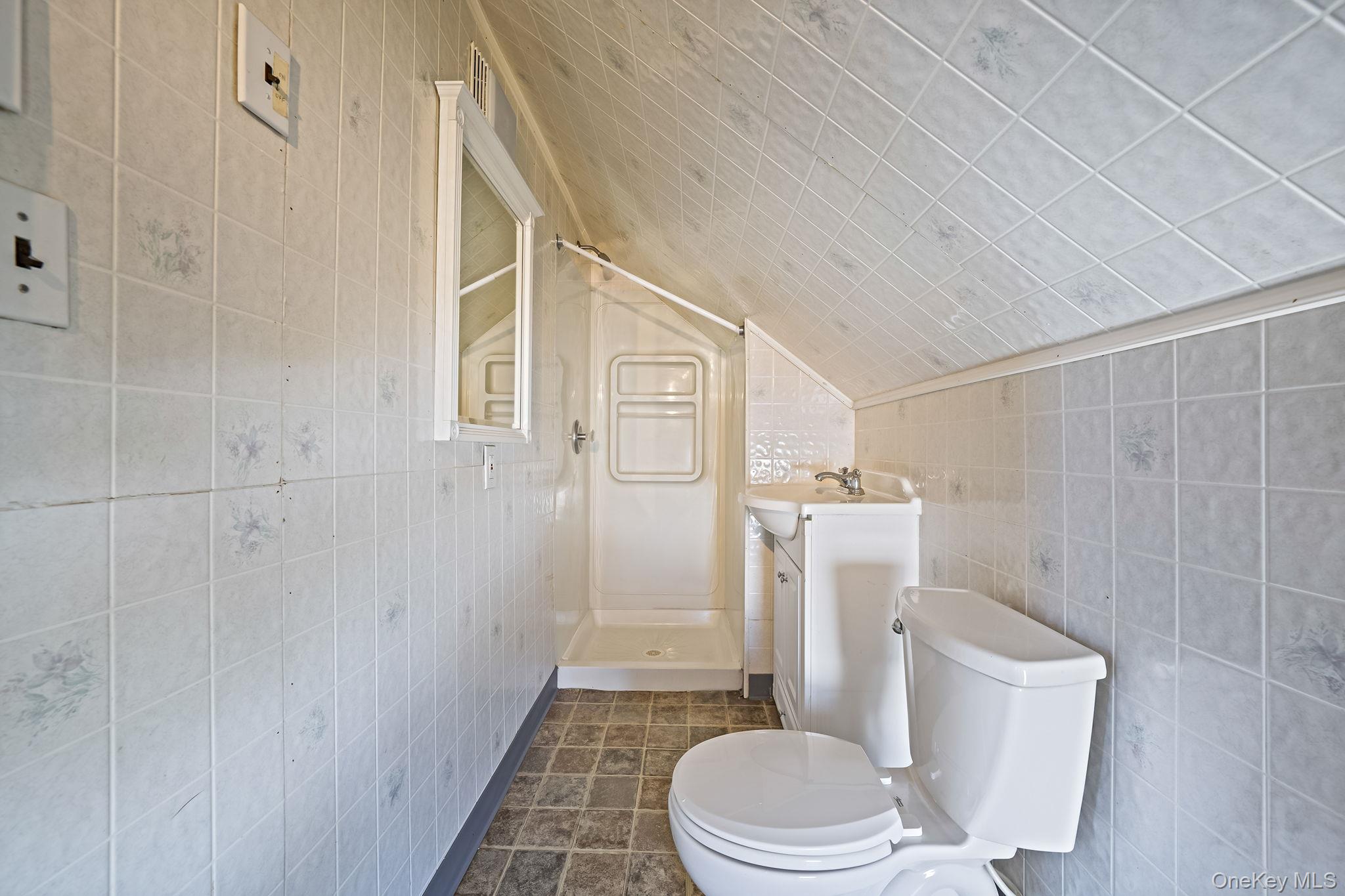 2001 North Jerusalem Road East Meadow, NY 11554 - Photo 21 of 31 a white toilet sitting next to a bathroom sink and a shower