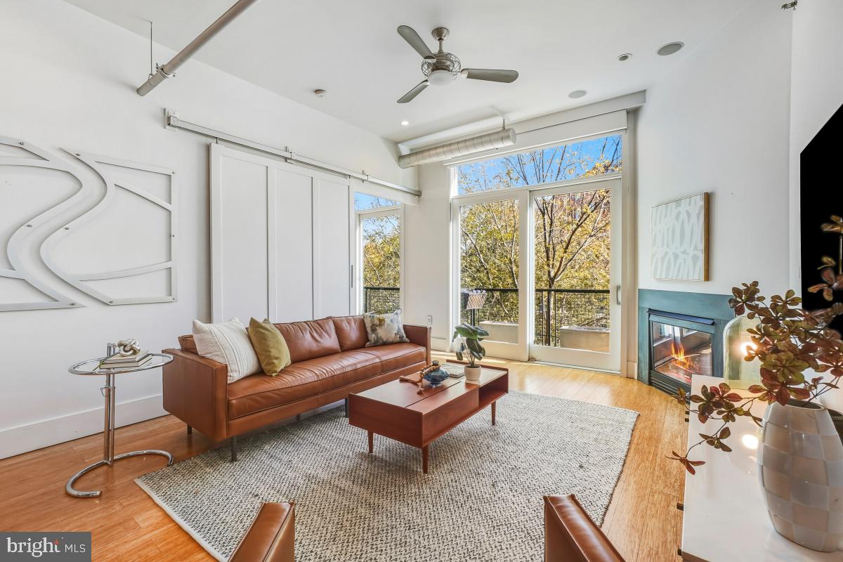 1700 Kalorama Road Northwest, Unit 407 Washington, DC 20009 - Photo 14 of 30 a living room with furniture a flat screen tv and a large window