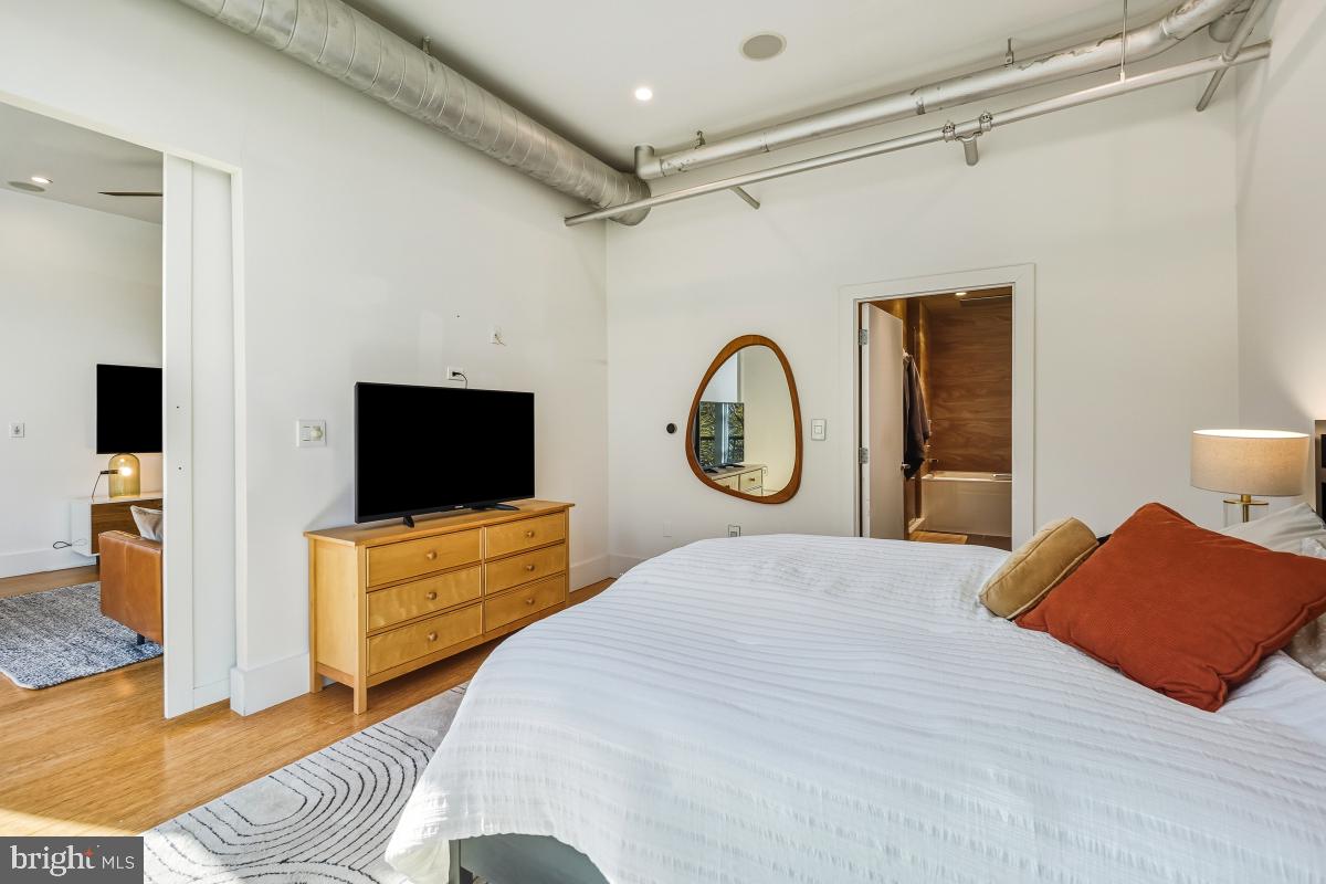 1700 Kalorama Road Northwest, Unit 407 Washington, DC 20009 - Photo 18 of 30 a bedroom with a bed and a flat screen tv
