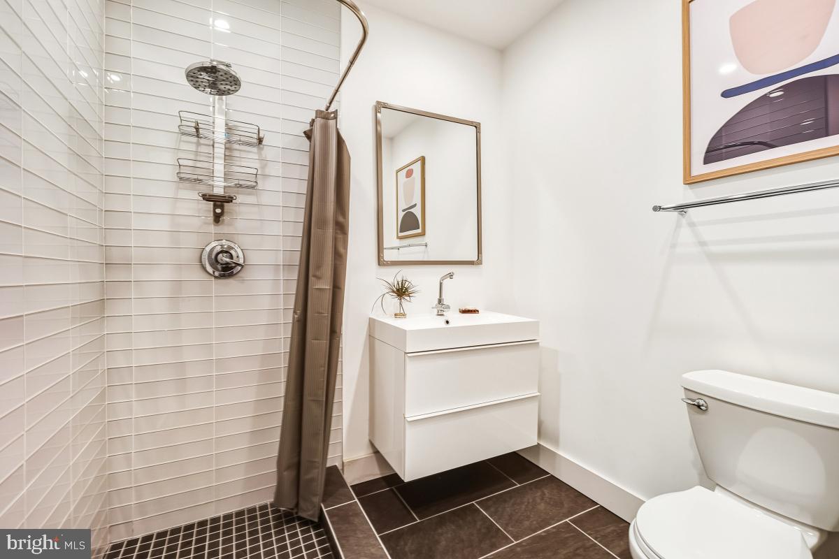 1700 Kalorama Road Northwest, Unit 407 Washington, DC 20009 - Photo 23 of 30 a bathroom with a sink toilet and shower