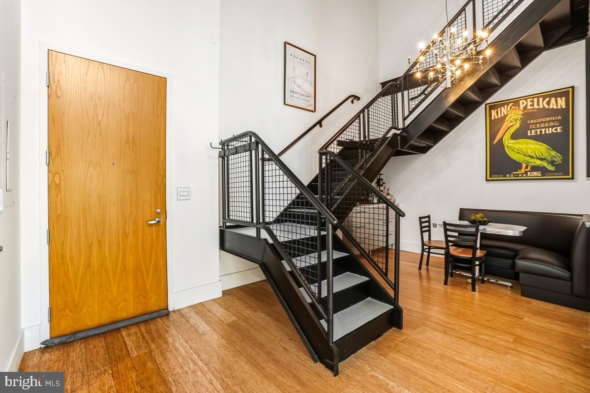 1700 Kalorama Road Northwest, Unit 407 Washington, DC 20009 - Photo 4 of 30 a living room with stairs and a wooden floor