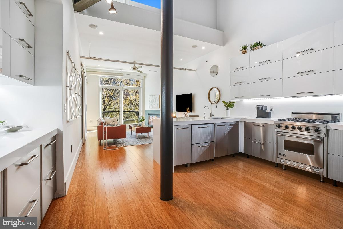 1700 Kalorama Road Northwest, Unit 407 Washington, DC 20009 - Photo 7 of 30 a view of a kitchen with a sink wooden floor and windows