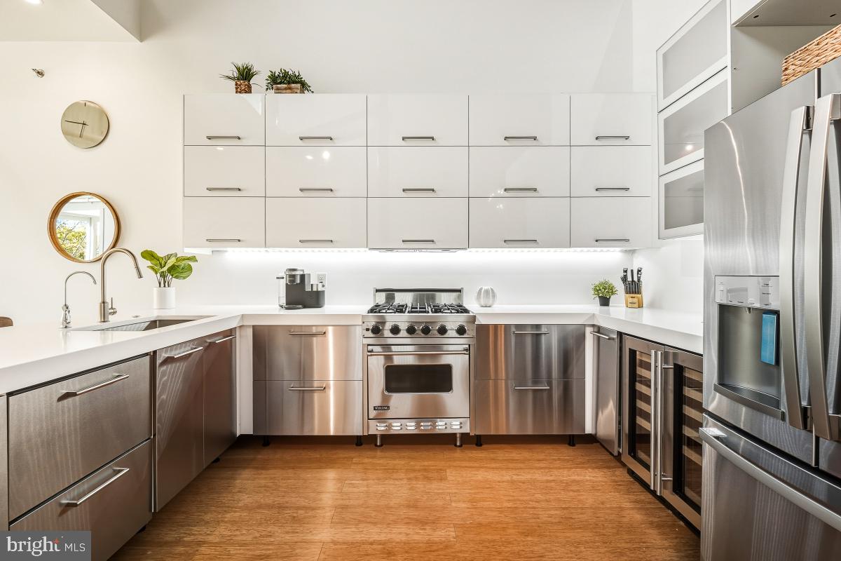 1700 Kalorama Road Northwest, Unit 407 Washington, DC 20009 - Photo 8 of 30 a kitchen with stainless steel appliances granite countertop a stove a sink and a refrigerator