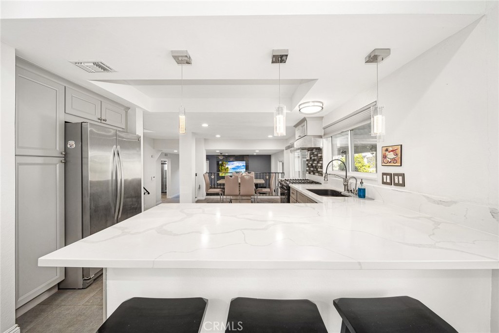 12 Rolling Hills Drive Phillips Ranch, CA 91766 - Photo 12 of 40 a large kitchen with kitchen island a sink table and chairs