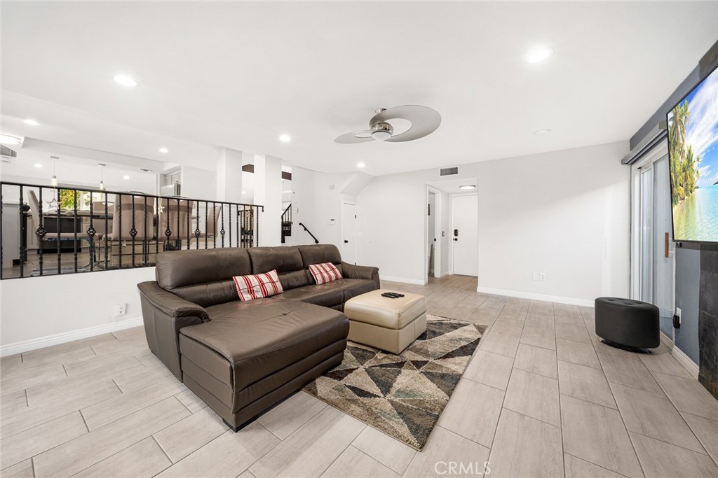 12 Rolling Hills Drive Phillips Ranch, CA 91766 - Photo 19 of 40 a living room with furniture a ceiling fan and a rug