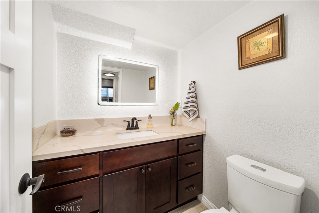 12 Rolling Hills Drive Phillips Ranch, CA 91766 - Photo 20 of 40 a bathroom with a toilet sink vanity and mirror