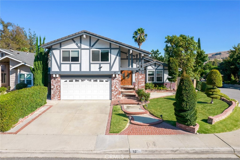 12 Rolling Hills Drive Phillips Ranch, CA 91766 - Photo 2 of 40 a front view of a house with garden