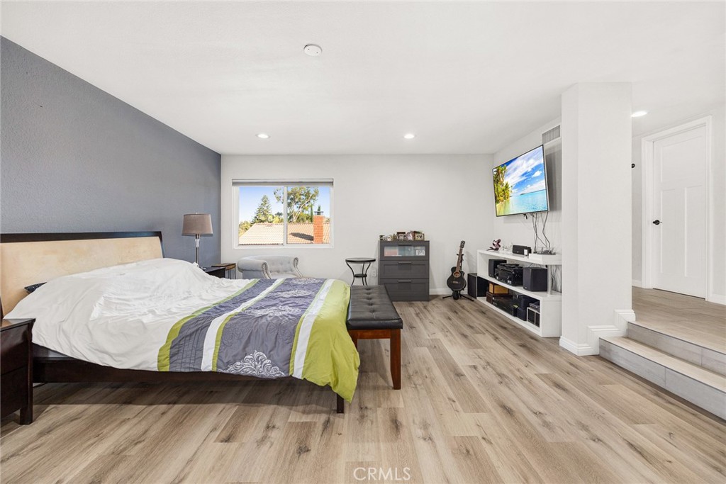 12 Rolling Hills Drive Phillips Ranch, CA 91766 - Photo 23 of 40 a spacious bedroom with a bed a dresser and wooden floor