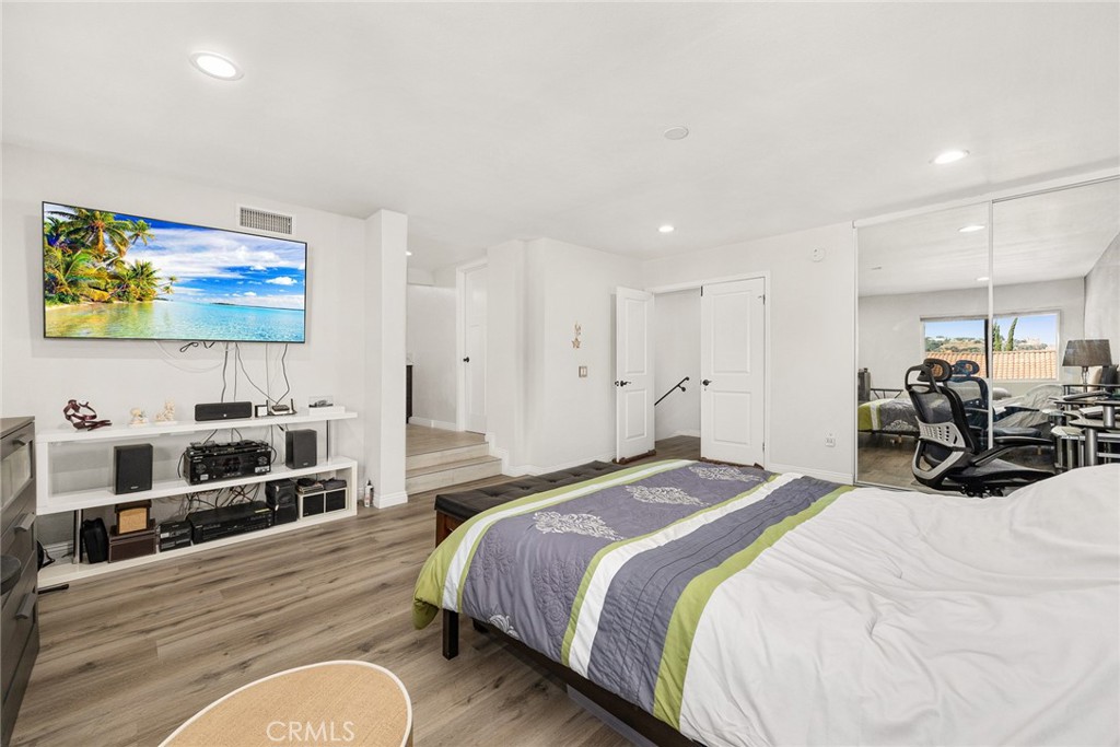 12 Rolling Hills Drive Phillips Ranch, CA 91766 - Photo 24 of 40 a spacious bedroom with a bed a couch and a flat screen tv