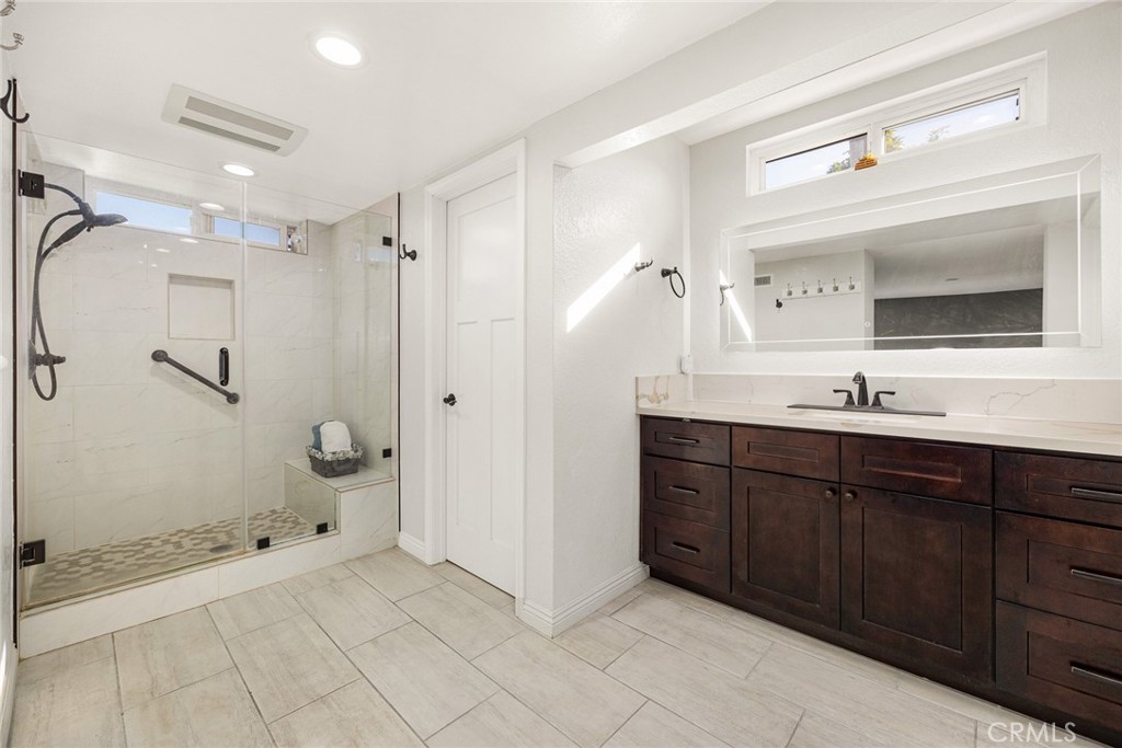 12 Rolling Hills Drive Phillips Ranch, CA 91766 - Photo 25 of 40 a spacious bathroom with a granite countertop sink mirror and shower