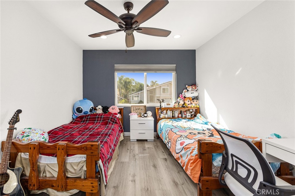 12 Rolling Hills Drive Phillips Ranch, CA 91766 - Photo 29 of 40 a bedroom with two beds and a chandelier