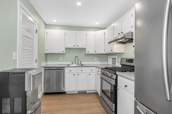 a kitchen with stainless steel appliances granite countertop a stove and a sink