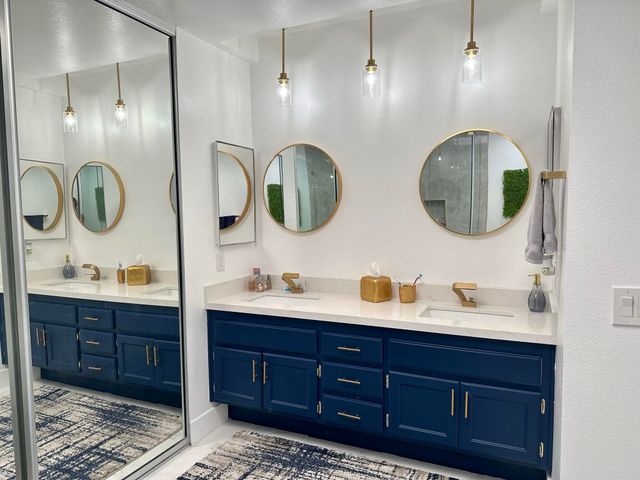 a bathroom with a double vanity sink and a mirror