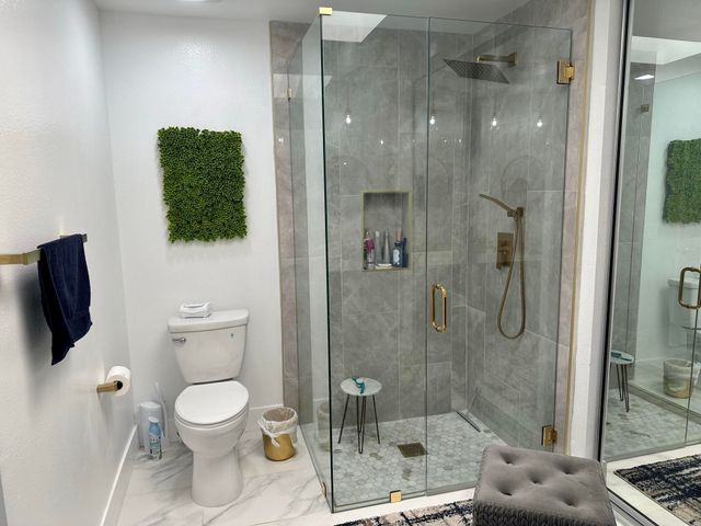 a bathroom with a toilet a sink and shower