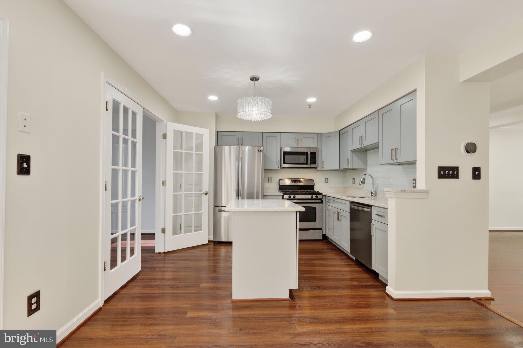 8612 Fire Rock Road Laurel, MD 20724 - Photo 13 of 57 a kitchen with white cabinets and stainless steel appliances