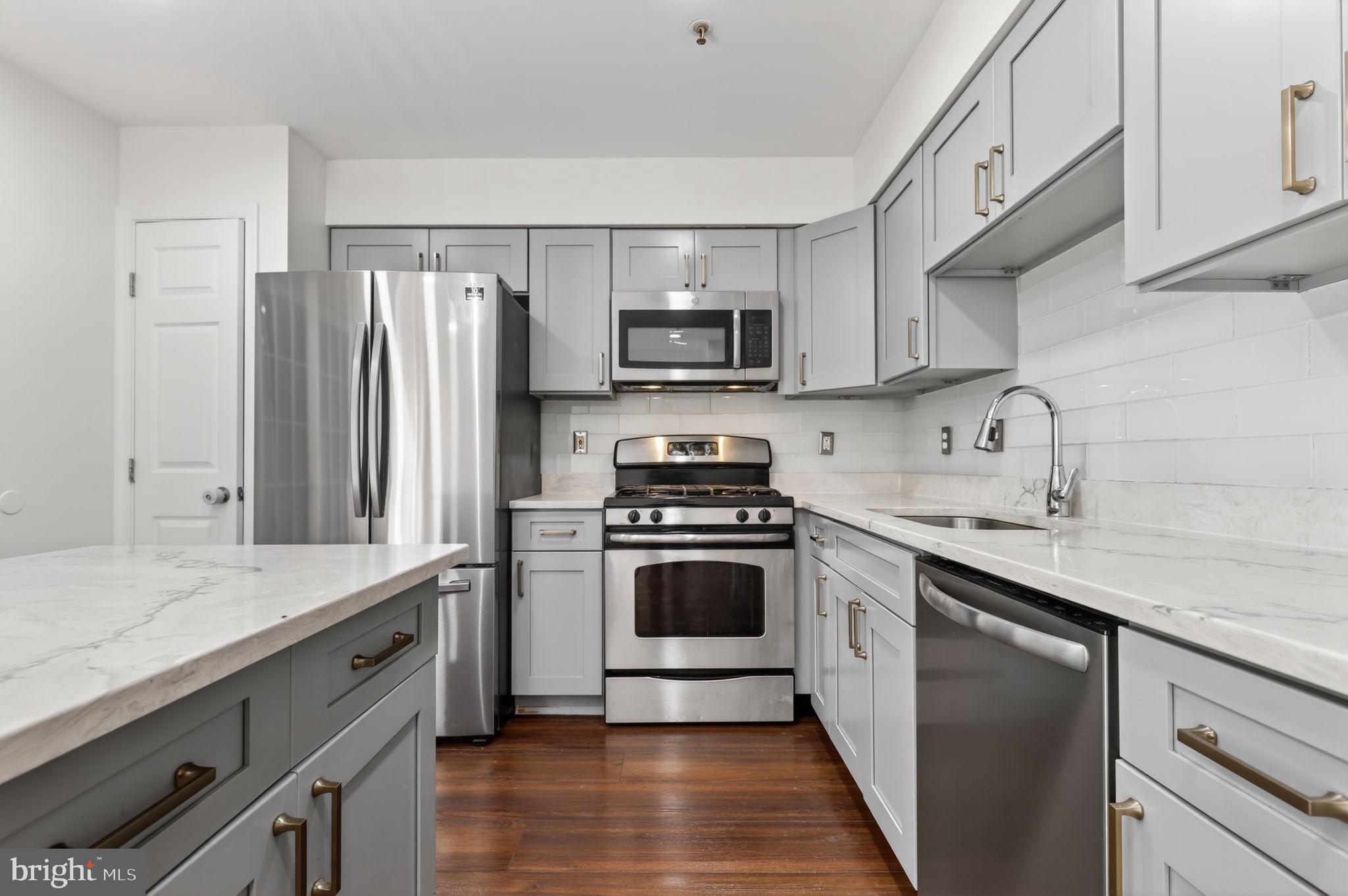 8612 Fire Rock Road Laurel, MD 20724 - Photo 14 of 57 a kitchen with stainless steel appliances granite countertop a sink stove and refrigerator