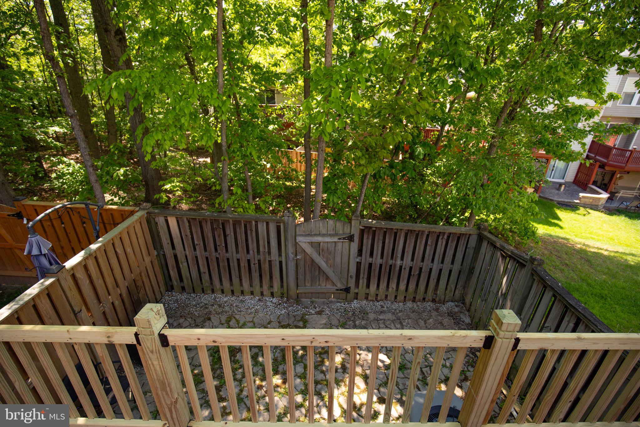 8612 Fire Rock Road Laurel, MD 20724 - Photo 24 of 57 a view of deck with wooden fence and trees